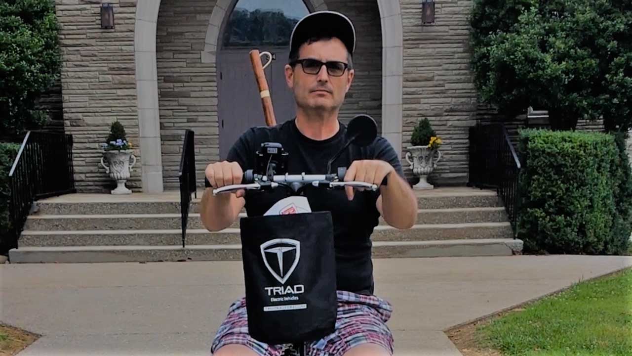 Chris on his scooter looking rugged